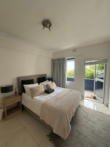 a bedroom with a large bed and a window at Cape Town Apartment, Sea View in Cape Town