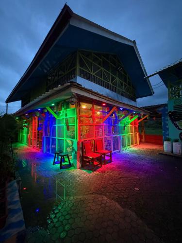 a building lit up with green and purple lights at Olivier in Butuan