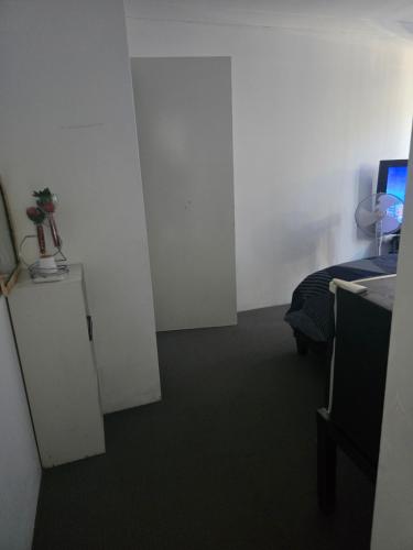 a room with a room with a bed and a computer at Baldivis Basic Apartment 2 in Baldivis