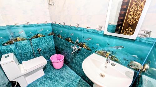 a bathroom with a sink and a toilet and a mirror at Lhamu homestay in Chug