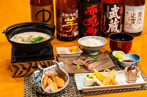 a table topped with plates of food and bowls of food at Okayama International Hotel in Okayama