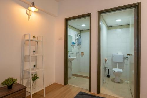 a bathroom with a toilet and a glass shower at Happy Stay Golden Hills Genting in Genting Highlands