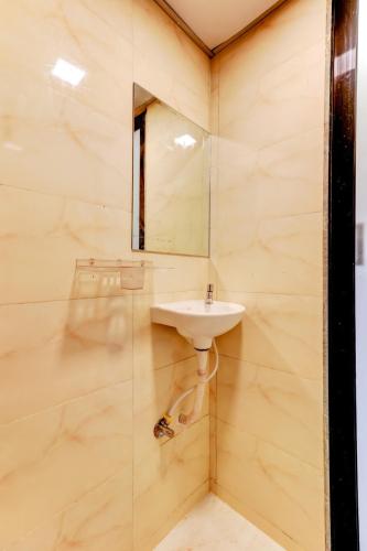a bathroom with a sink and a mirror at Hotel Summer Inn in Mumbai