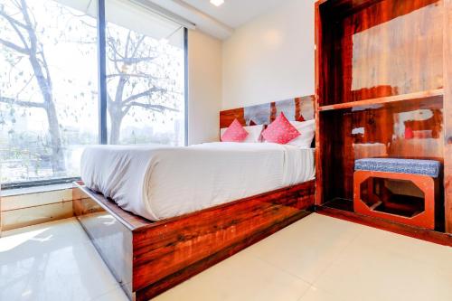 a bedroom with a bed and a large window at Hotel Summer Inn in Mumbai