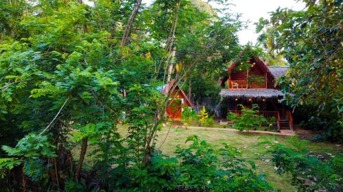 a small house in the middle of a forest at Nature Rest Ashored in Sigiriya
