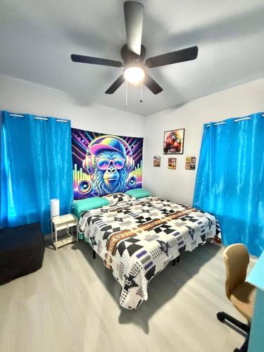 a bedroom with a bed with a painting on the wall at Babyproofed, CinemaHome, TCU,DikciesArena,Stockyard,FortWorth in Fort Worth