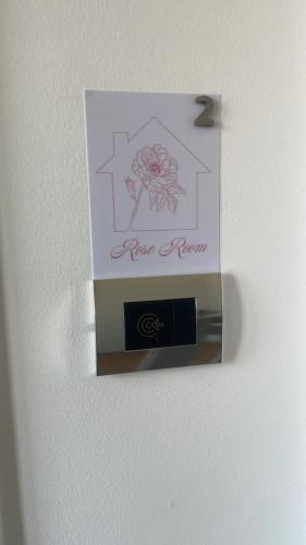 a card on a wall with a new renew sign at Airport Flower Rooms in Ronchi dei Legionari