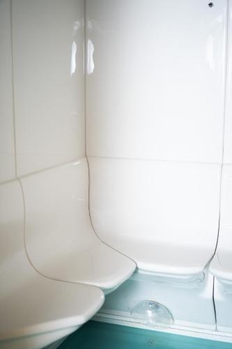 a white toilet in a room with a window at Hôtel de Gruyères in Gruyères