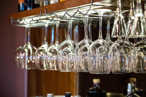 a bunch of wine glasses hanging from a rack at Tesla's Gastro House Plitvice in Plitvička Jezera