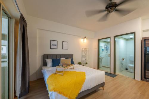 a bedroom with a bed with a laptop on it at Happy Stay Golden Hills Genting in Genting Highlands