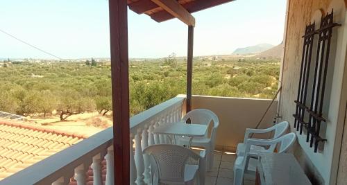 a balcony with chairs and a table and a view at Villa Elma in Gouves