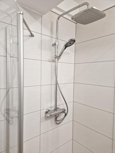 a shower with a shower head in a bathroom at WeserPension in Brake