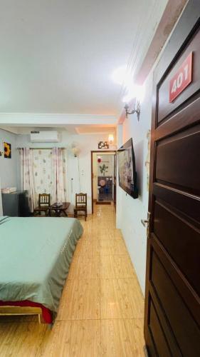 a bedroom with a bed and a living room at Studio Kéo lưới in Hanoi