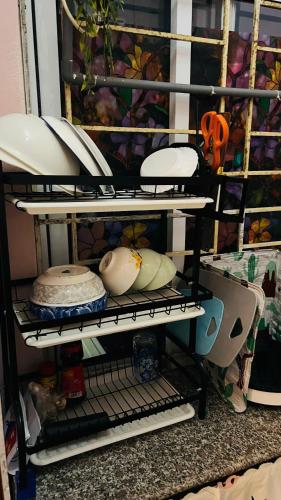 a shelf with plates and other items on it at Studio Kéo lưới in Hanoi