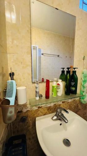 a bathroom counter with a sink and a mirror at Studio Kéo lưới in Hanoi