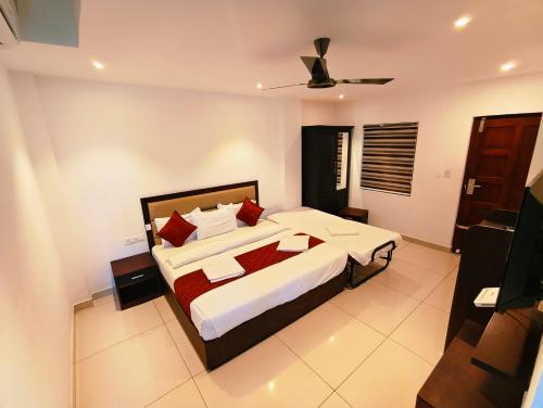 a bedroom with a large bed with red pillows at Spring Valley Resort in Thekkady