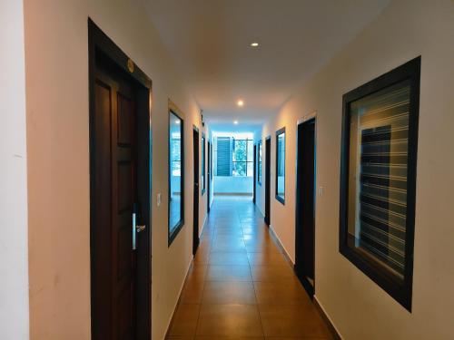 a hallway with a row of paintings on the walls at Spring Valley Resort in Thekkady