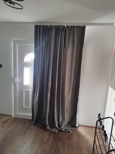 a gray curtain in a room with a door at Salvatori in Garić
