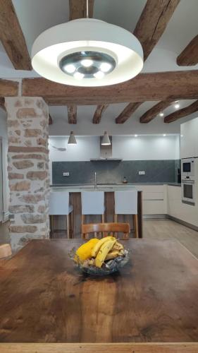 a bowl of bananas on a table in a kitchen at Cal Serraller in Miravet