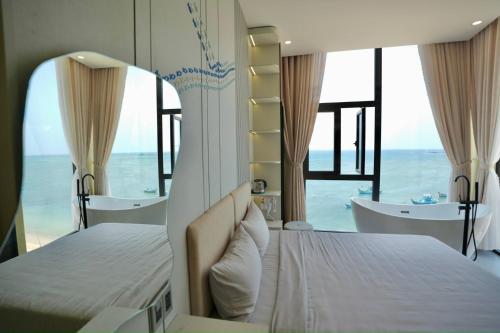 a bedroom with a bed and a view of the ocean at Memory Beach Hotel Phú Quý in Cu Lao Thu