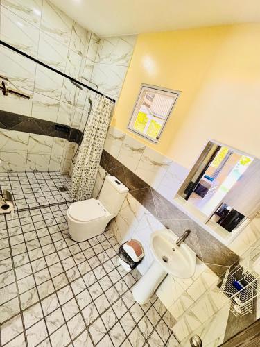 a bathroom with a toilet and a sink at La'Cris Homestay in Ocoy