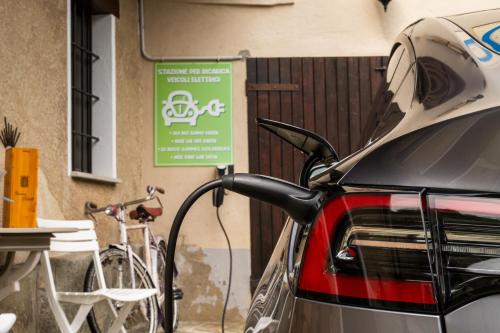 a car parked next to a bike next to a sign at La Meira di Lucia B&B in Rossana