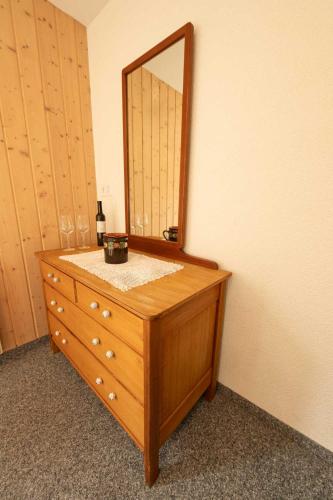 a wooden dresser with a mirror on top of it at Lehmann's Herberge Hostel in Grindelwald