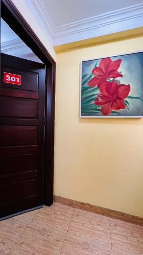 a door in a room with a painting on the wall at Studio Kéo lưới in Hanoi