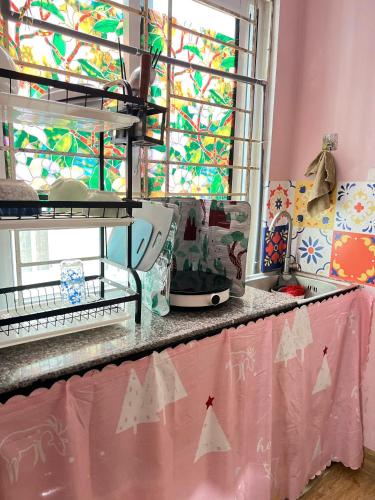 a kitchen counter with a sink and a window at Studio Kéo lưới in Hanoi