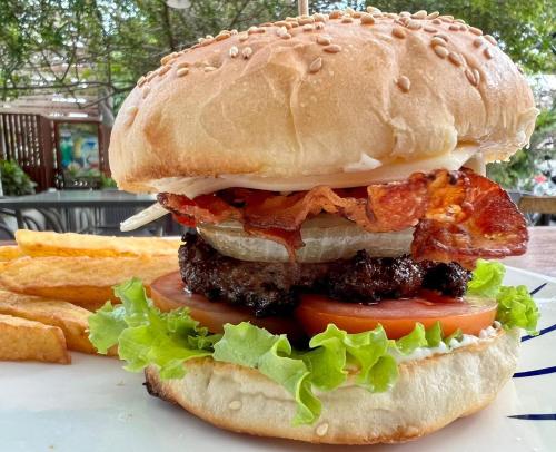 a sandwich on a plate with french fries at Luang Prabang Inn 1 in Luang Prabang