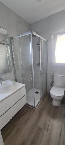 a bathroom with a shower and a toilet and a sink at Palmera in Miami Platja