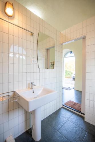 a bathroom with a sink and a mirror at Dome In Doi in Mon Jam