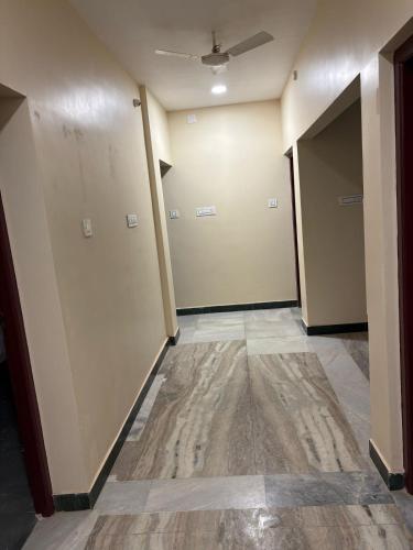 an empty hallway with two doors and a tile floor at Rio Grande ApartHotel in Madurai