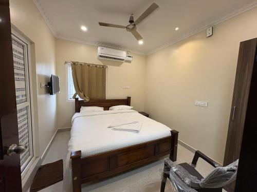 a bedroom with a bed and a ceiling fan at Rio Grande ApartHotel in Madurai