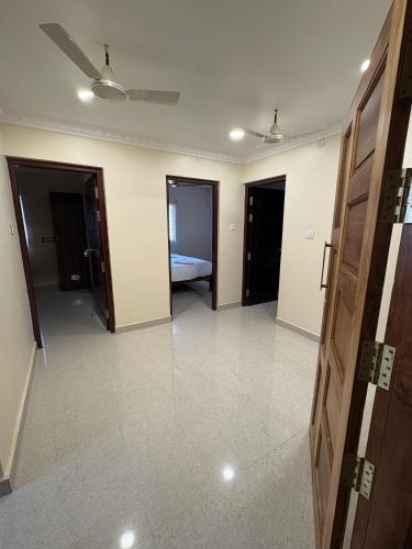 an empty room with two doors and a bedroom at Rio Grande ApartHotel in Madurai
