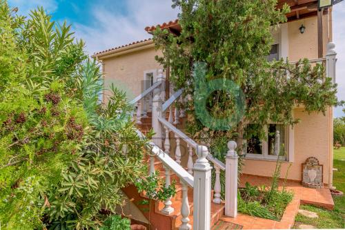 a house with a staircase in front of it at Harmony Hideaway in Dhíkella