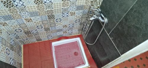 a shower in a bathroom with a shower head at hostel Banana in Tangier