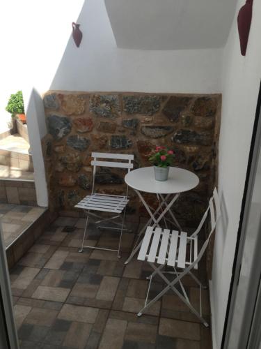 a table and two chairs and a table and a table at Denise House in Vromolithos