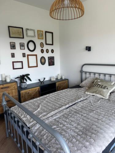 a bedroom with a bed and a wall with pictures at Apartamenty Okrętowa 23 Bolek Lolek in Bielsko-Biala