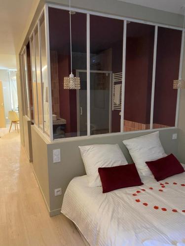 a bedroom with a large bed with red roses on it at Bonbon Love, Gard, Ardèche, Cévennes in Saint-Ambroix