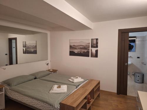 a bedroom with a bed and a wooden table at appartamenti ACTIVESTAY in Arco