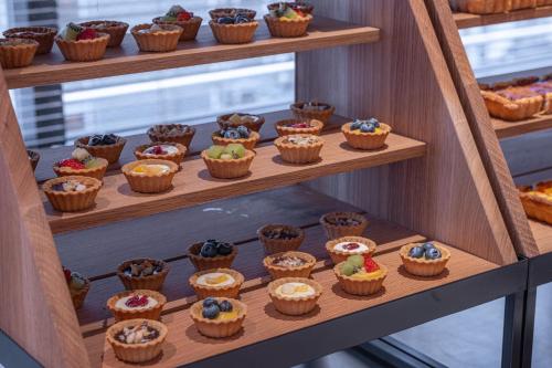 a display case filled with lots of cupcakes at THE BASEMENT HOTEL OsakaHonmachi in Osaka