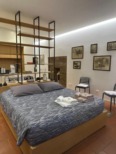 a bedroom with a large bed with two chairs at La Suite del Doge - Parking in Treviso