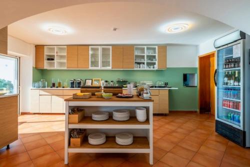 a kitchen with a counter and a refrigerator at VilaFoia in Monchique