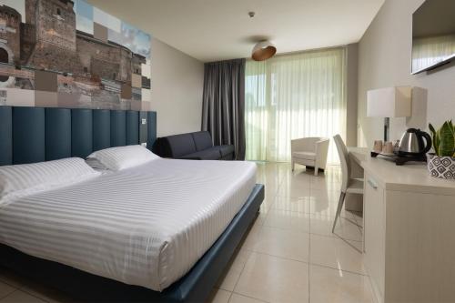 Postel nebo postele na pokoji v ubytování Mercure Hotel Rimini Artis