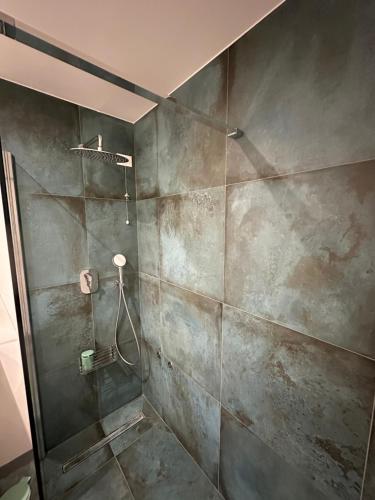 a bathroom with a shower with a shower head at La Suite del Doge - Parking in Treviso