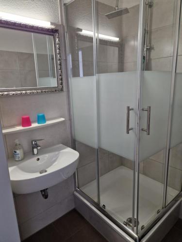 a bathroom with a shower and a sink at Pension Antalya in Friedrichshafen