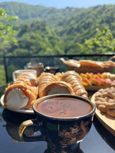 a table with a plate of pastries and a cup of coffee at Cottege Merisi's Side in Merisi