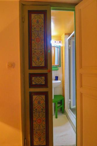 a door in a room with a bathroom at Les Matins Bleus in Essaouira