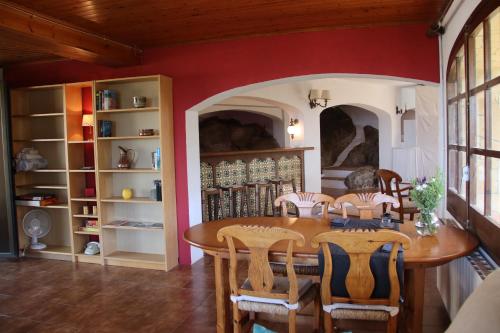 a dining room with a table and chairs at cave house with sea views in Santa Susanna
